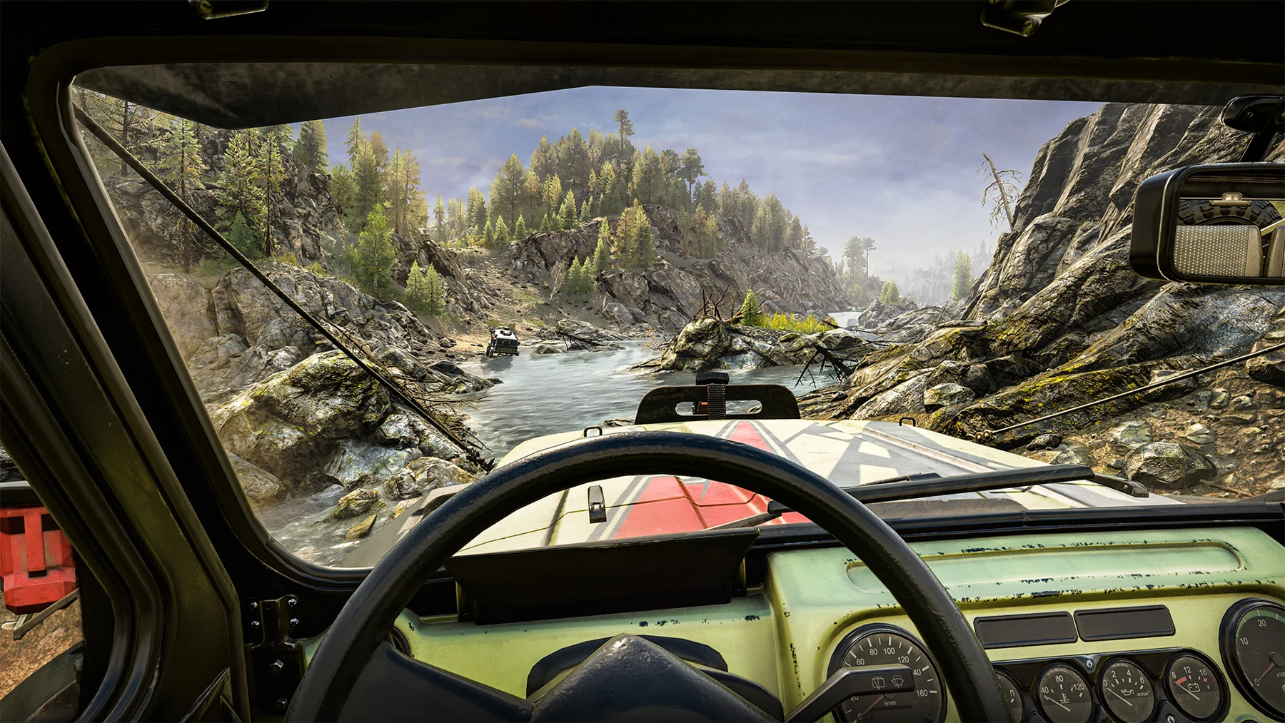 A rocky river approach seen from a vehicle cockpit in an official Expeditions screenshot.